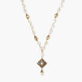 Y-shaped necklace with freshwater pearls, gold filigree stations, and ornate diamond-shaped centerpiece with pearl drop